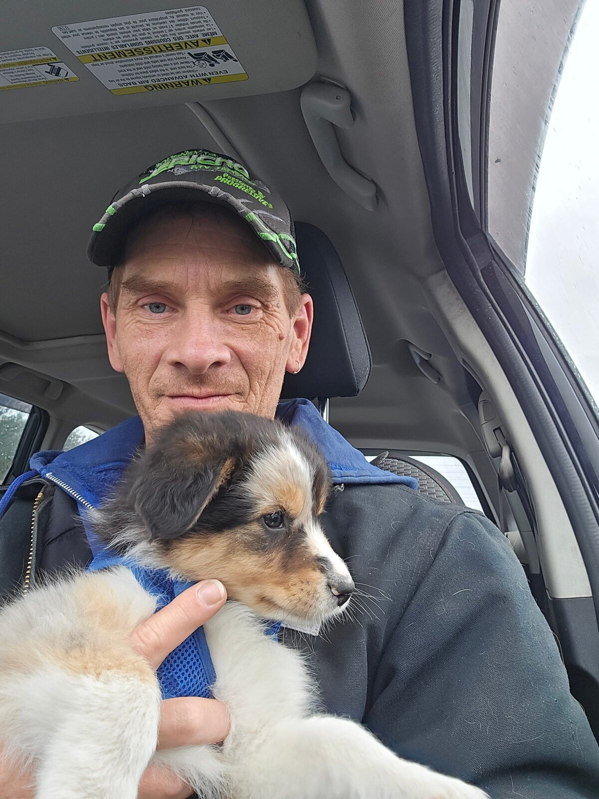 Donald Bagley JR, owner of Bar D Ranch Drone Service, holding a puppy